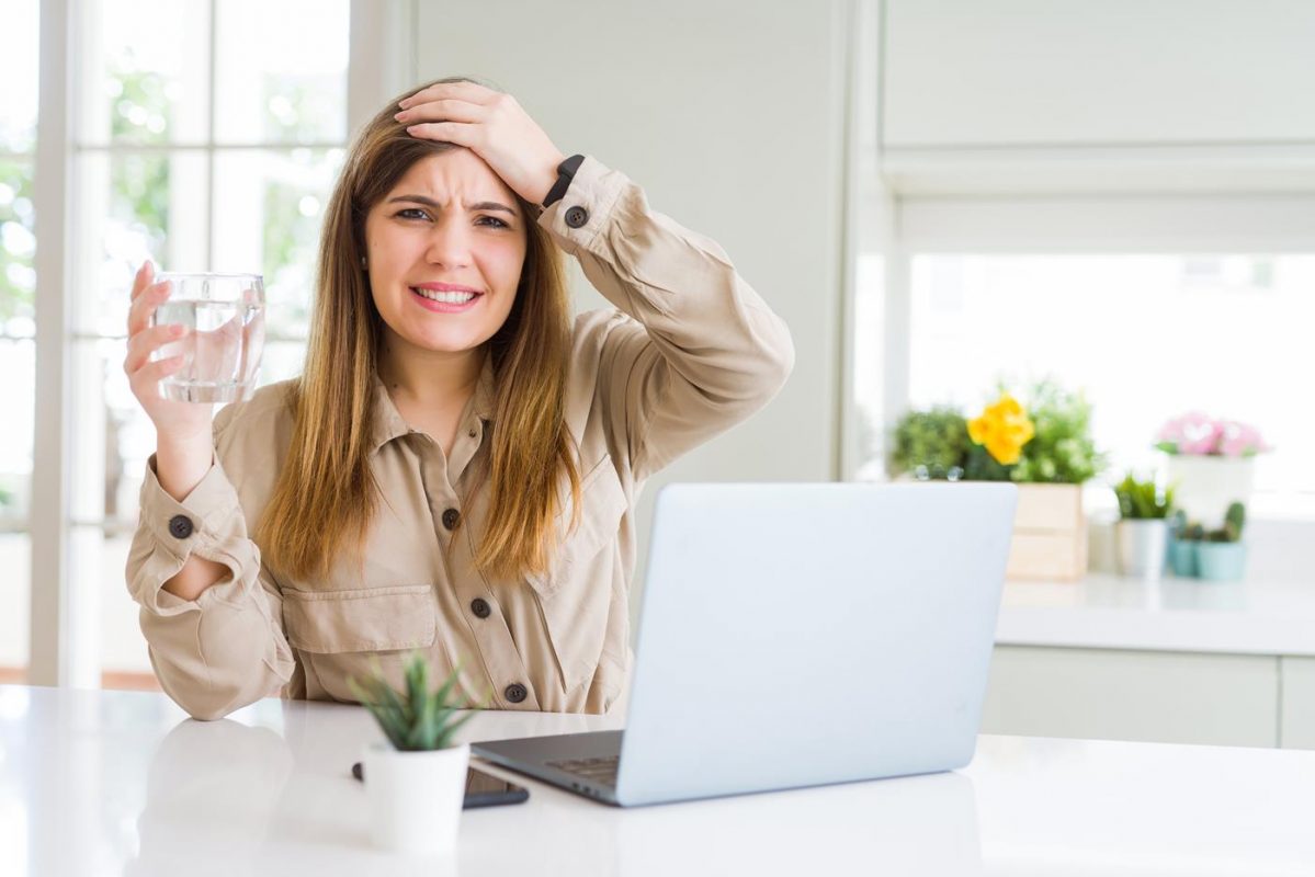 Businesswoman holding a glass of water in a business crisis